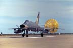 Picture of an F-100D landing, drag chute out.Click on this picture to 
          start the video.